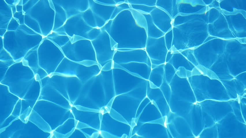 An amazing view of swaying turquiose waters in a modern swimming pool with shimmering curvy lines making a cheerful and arty background.  Royalty-Free Stock Footage #1015960645