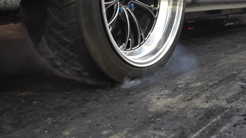 Drag racing car burn tire at start line