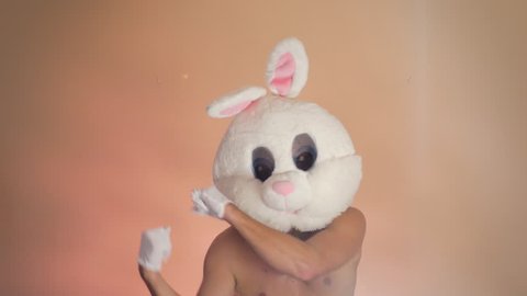 Shirtless man dancing with bunny mask, loop