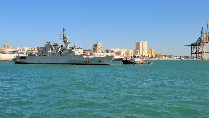 Wide Angle: Tugboat Towing a Military Boat