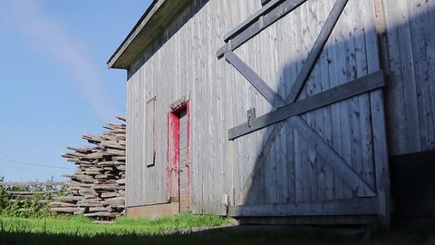 Barn door and blue sky with old gray wood.