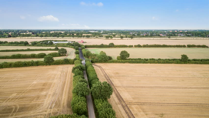 Drone lapse / Hyper lapse of agriculture fields on a sunny day