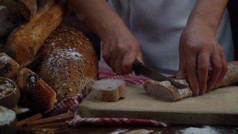 woman cutting bread in the bakery.