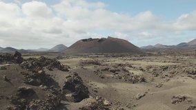 Amazing volcanic landscape and crater on the island of Lanzarote, aerial drone video footage