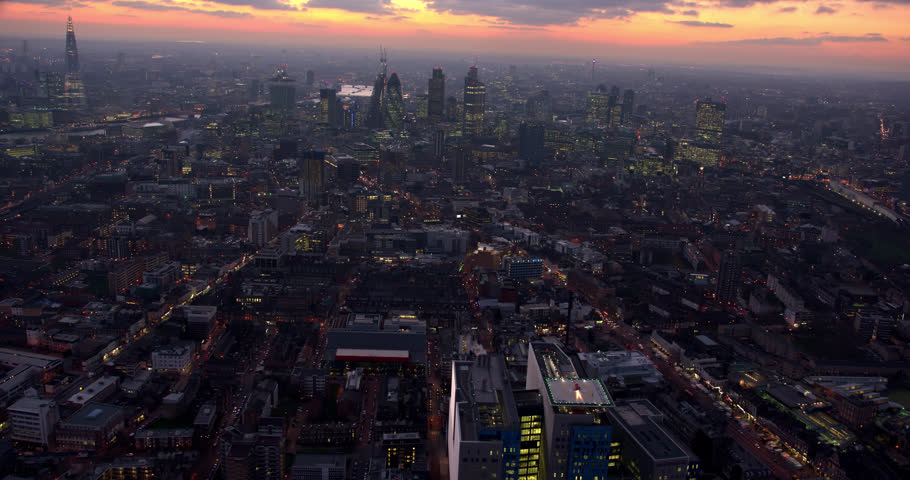 Beautiful wide aerial shot above the city of London. Stunning sunset in the background. Royalty-Free Stock Footage #1015990201