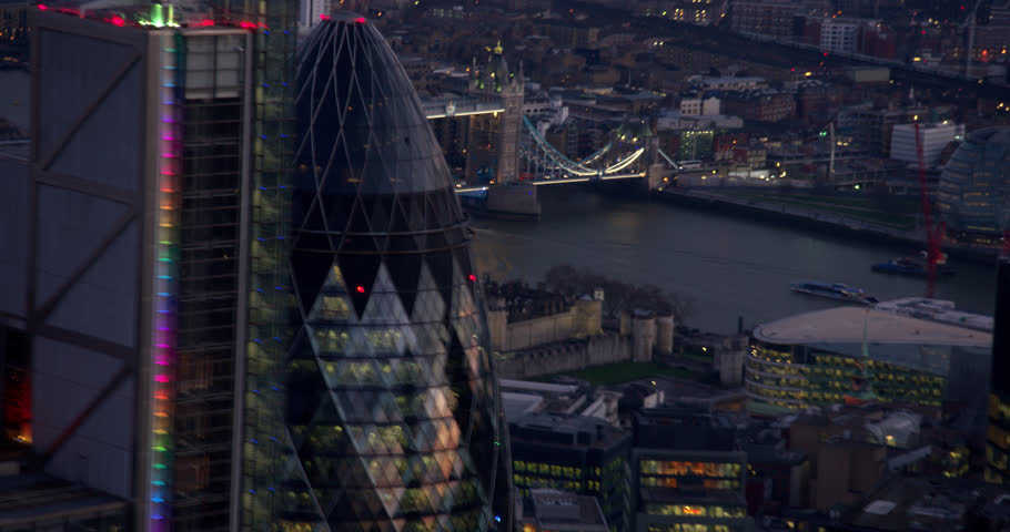 Aerial shot of London's Air Ambulance close to the Heron Towers and 30 St Mary Axe skyscraper. River Thames and Tower Bridge in the background. Royalty-Free Stock Footage #1015990207