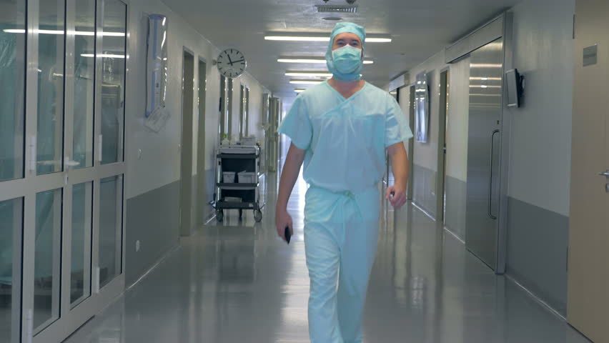 Adult male doctor is passing by the hospital hall | Shutterstock HD Video #1015996144