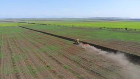 Tractor Ploughing Field Aerial Video. Agriculture Industry Soil Cultivation Preparation For Sowing Seed Or Planting. Aerial View Of Tractor Ploughing Field.  
