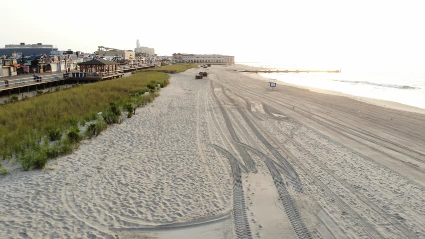 Aerial View Of Drone Flying Over an Isolated Beach Along The New Jersey Shoreline and Boardwalk 
