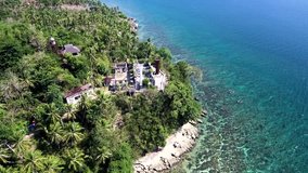 Aerial drone video of an old 18th century spanish colonial lighthouse built beside the beach in Guimaras in the Philippines, Southeast Asia. Guisi lighthouse is second to the oldest watchtower .