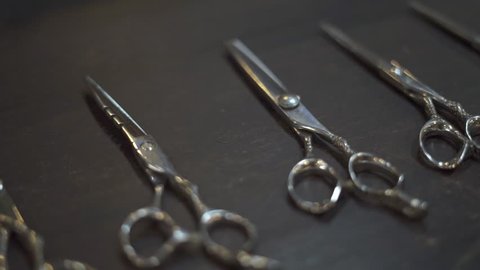 Hairdressing scissors and barber accessories in hair salon close up. Professional tools for haircut in barber shop. Hairdressing concept