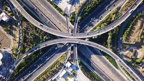Aerial drone high speed video of urban elevated toll road junction and interchange overpass in National road and Attiki odos of Attica, Athens, Greece