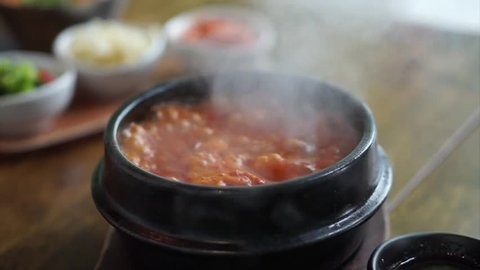 Kimchi Tofu Soup served in hot clay pot, One of the most-loved of all the stews in Korean cuisine, Most popular food in Korea.