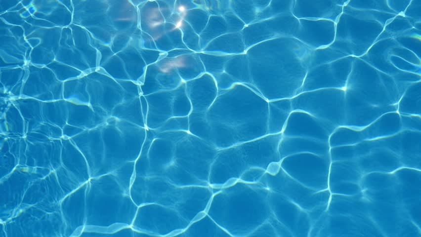 A marvelous view of swaying cyan-blue waters in a swimming pool with sparkling grid playing cheerfully in summer in slow motion Royalty-Free Stock Footage #1016025508