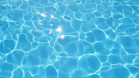 A wonderful view of playing celeste waters in a swimming pool with a sparkling and changing web shaping a cheery askew background. 