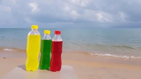 Video colored bottles on the beach near the sea