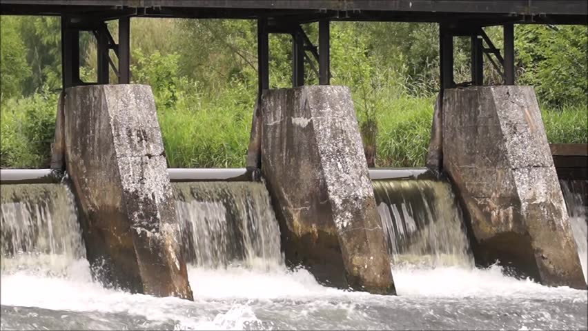An old dam of piling water in a river. Europe. Poland.