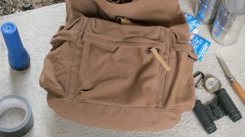 Survivalist packing bag of emergency evacuation gear closeup