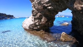 Video of tropical rocky arch with turquoise clear waters in iconic island of Antipaxos, Voutoumi beach, Ionian, Greece