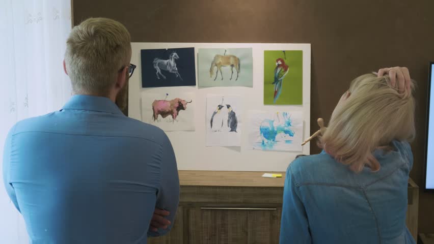 Student artists looking at their work