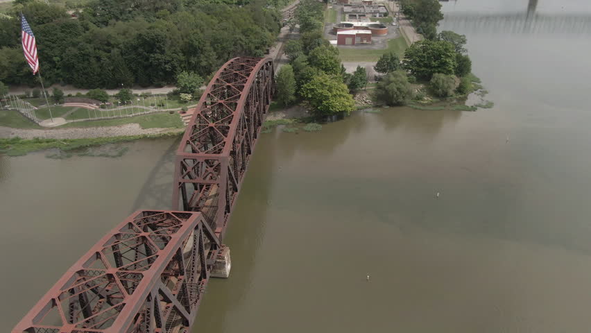 A slow orbit around a rusty railroad bridge over the Ohio River in western Pennsylvania. Pittsburgh suburbs. Part 2 of 2.  	