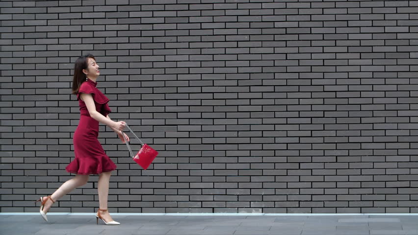 pretty young asain woman walking in the street in slow motion