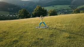 Aerial View Yoga woman is jogging in summer sunny day around trees and mountains background under sun light with blue sky, Drone 4K Video
