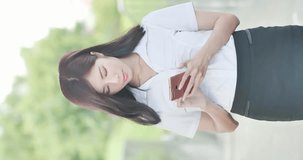 Vertical Video - businesswoman use phone and smile happily in outdoor