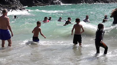 Kynance Cove, Cornwall, England. August 2018: People in the sea in at Kynance Cove in Cornwall