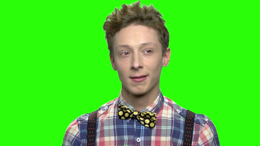 Daydreaming pensive teenage boy. Green screen hromakey background for keying.