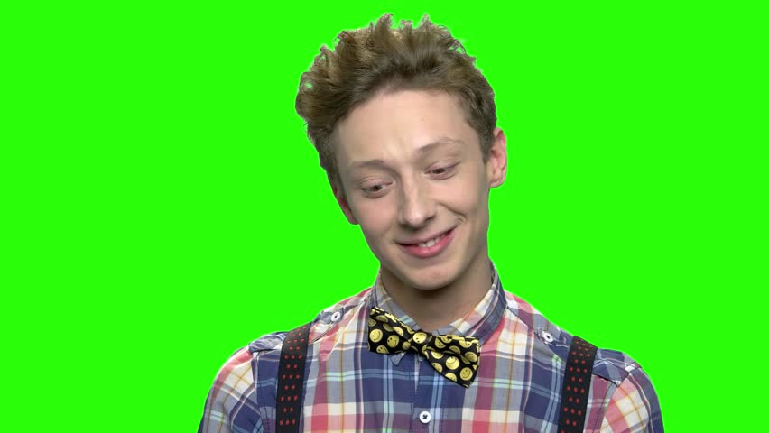 Teenage boy thinking about something nice. Green screen hromakey background for keying.