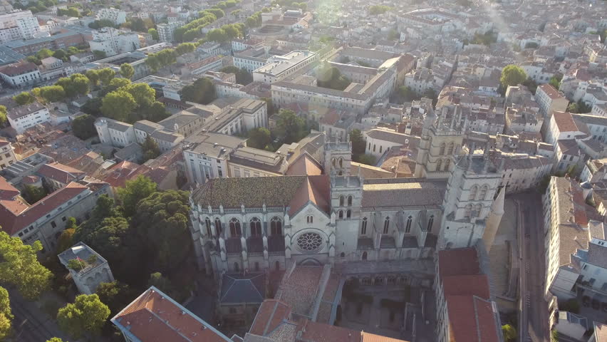 View from a drone flying around Montpellier cathedral during sunrise. France ecusson 