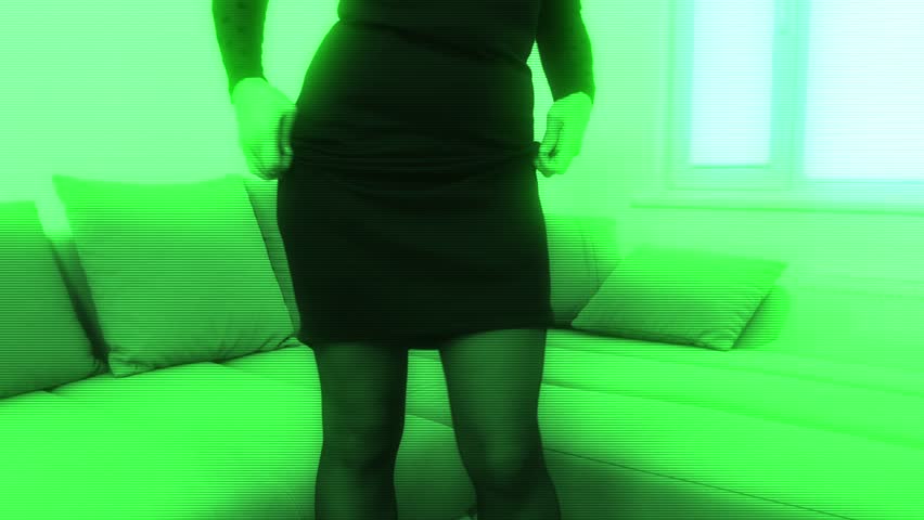 Woman in black stockings dance with green hologram effect