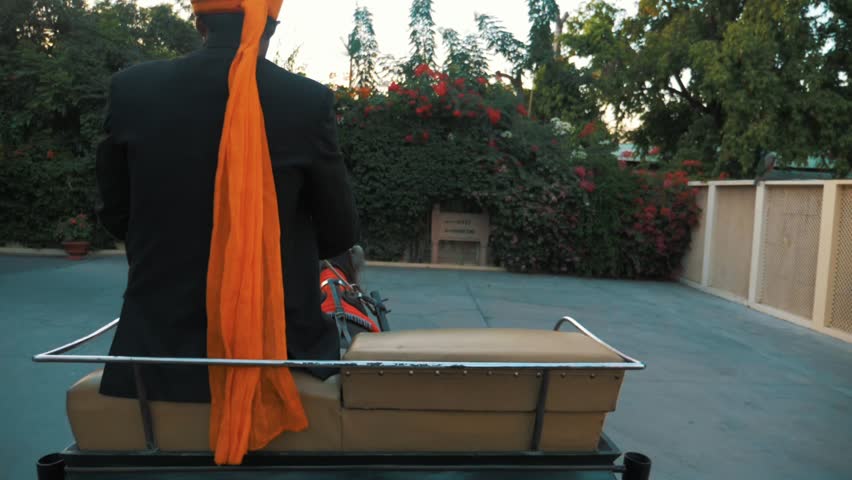 SLOW MOTION man in turban riding at Rambagh Palace Jaipur