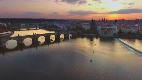 4K 3840x2160 Aerial sunrise video footage of world famous destination place - old architecture of Charles bridge (Karluv most) over Vltava river in Prague city, capital of Czech Republic, Europe