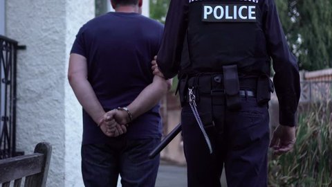 Cinematic Police Arrest With Criminal Led Away In Handcuffs. Part Of A Collection With A Variety Of 4K Camera Angles.