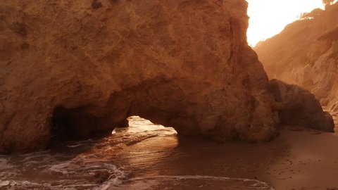 Dolly Shot of Malibu Arch Rocks and Sea Caves at Sunset