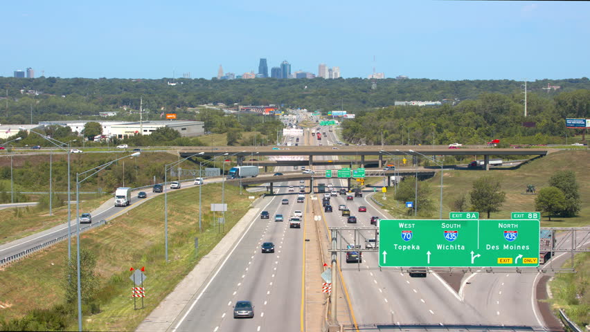 KANSAS CITY, MO - 2018: Interstate I70 Traffic Flowing To and From the Downtown Cityscape on the Horizon of a Sunny Day in Missouri | Shutterstock HD Video #1016092264