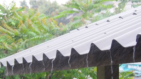 close up rain falling down to roof house