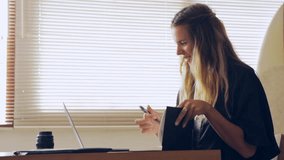 Beautiful young woman work with laptop. Write in notebook. Call smartphone. Happy girl working online. Study and learn with notebook computer. Modern business lady. Freelance work from home concept.