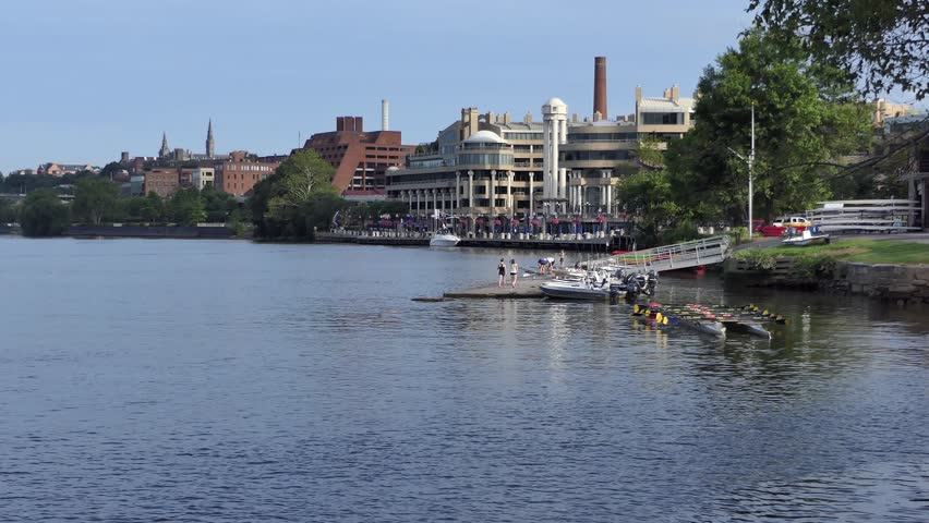 Washington DC waterfront view on Potomac River, Georgetown Waterfront boat station, park trees and buildings at sunny summer morning.