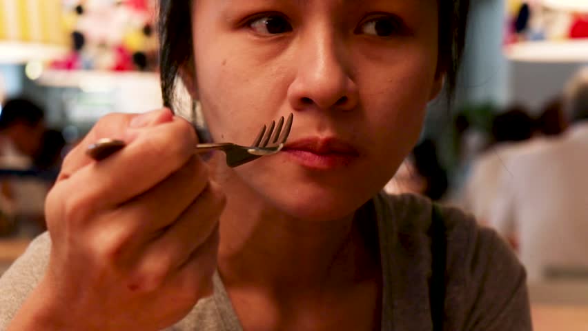Closeup portrait of asian woman who is having hypersensitive teeth while eating food. Royalty-Free Stock Footage #1016103301