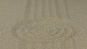 Concentric circle and lines on the sand, with a place for designer. Texture of sand. - Powered by Shutterstock - Get 15% off with code: PIKWIZARD15