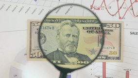 Study of a banknote fifty dollar, increasing with the help of a magnifying glass. - Powered by Shutterstock - Get 15% off with code: PIKWIZARD15