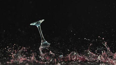 Breaking wine glass on black background, shooted with high speed cinema camera at 1000 fps. 4K footage.