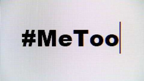 Typing the hashtag #MeToo on a computer monitor. Macro detail shot.