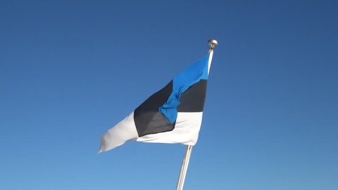 Flag of Estonia fluttering against the blue sky