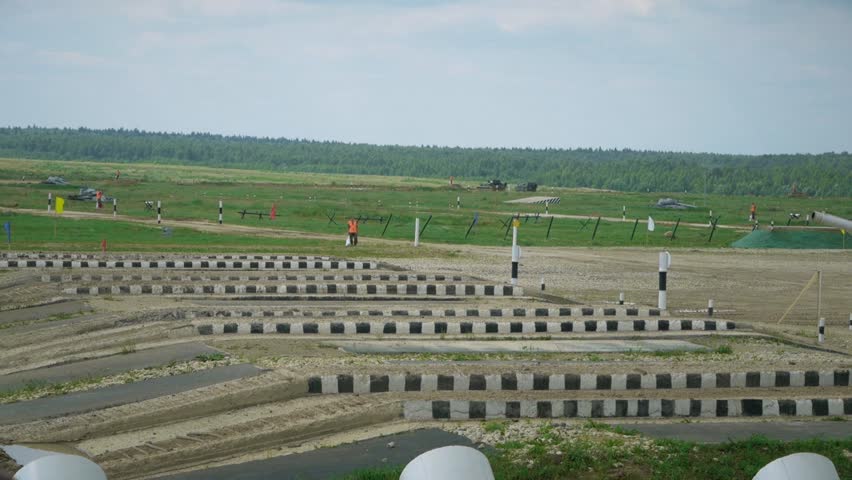 Rollers and caterpillars of a red tank during the passage of an obstacle