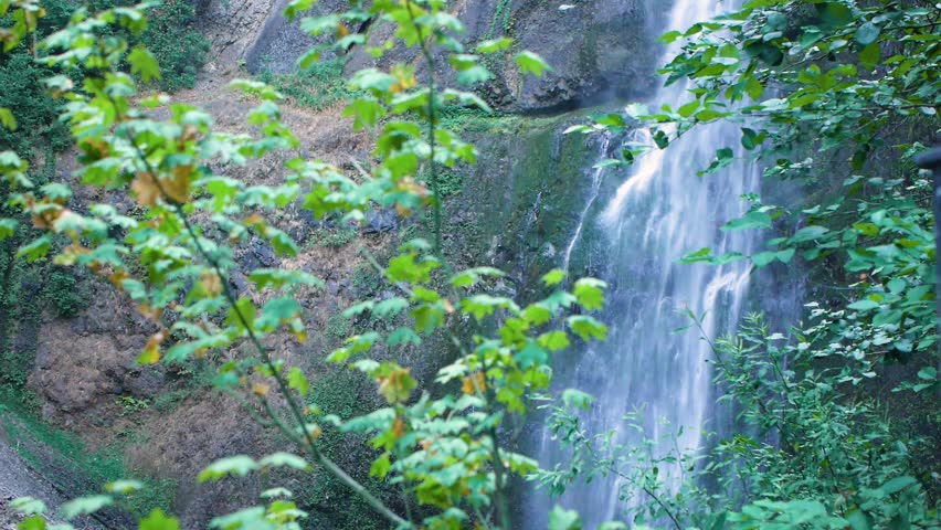 Waterfall Flows Down Rocky Mountain in Klamath Falls, Oregon. Wide Shot.