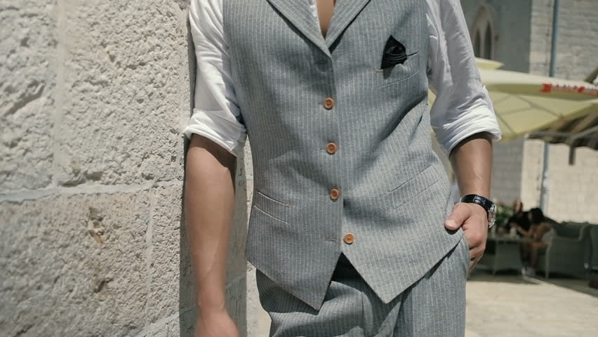 Attractive young fasion man in a suit posing in an old fortress. Slow motion
